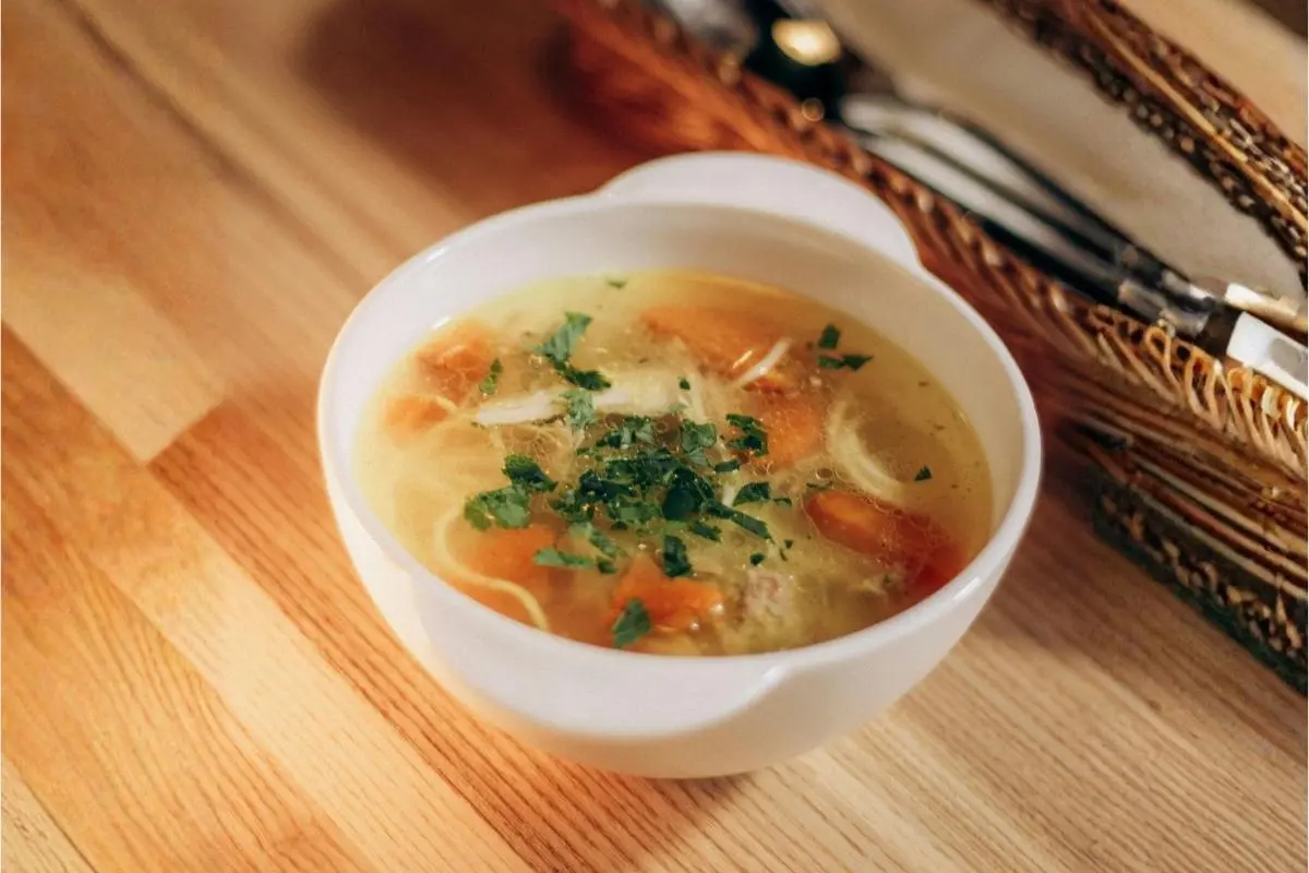 Homemade gut-healing bone broth in a ceramic mug for menopause relief