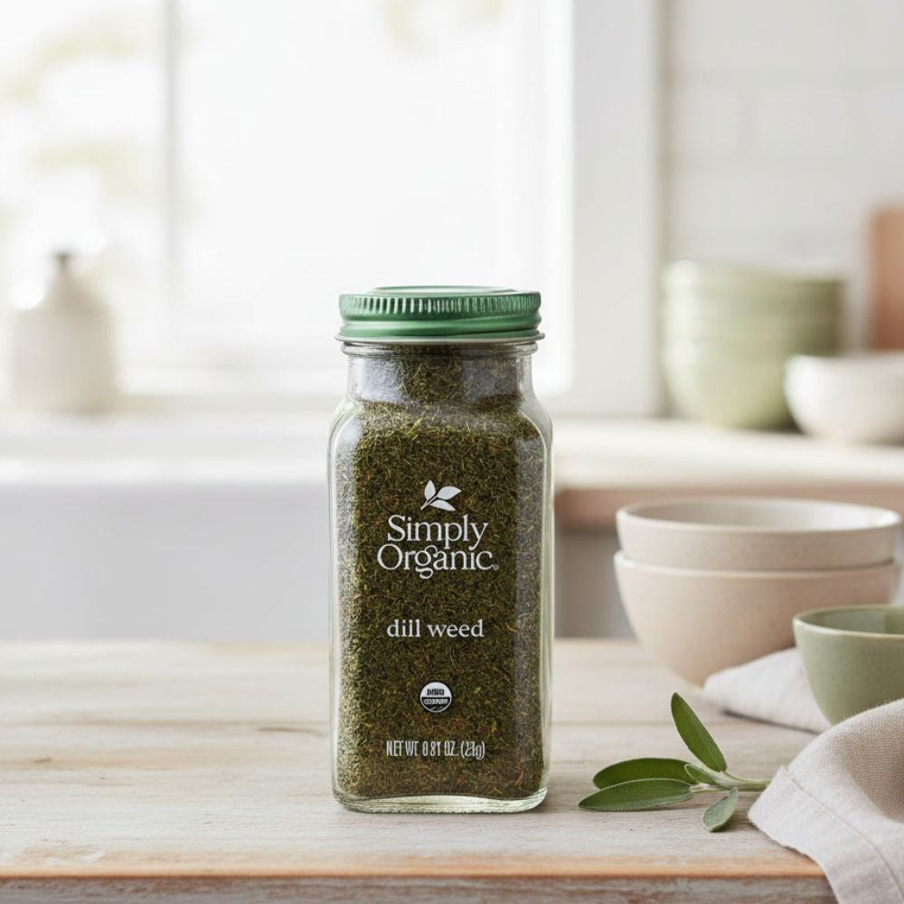 Simply Organic Dill Weed Certified Organic, 0.81 container on a kitchen counter with bowls behind him.