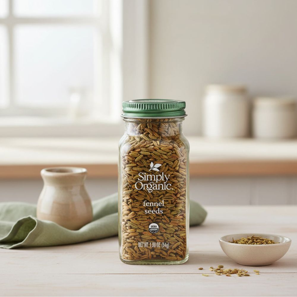 Simply Organic Whole Fennel Seed, 1,90 oz bottle on a kitchen counter with a bowl of seeds next to it.