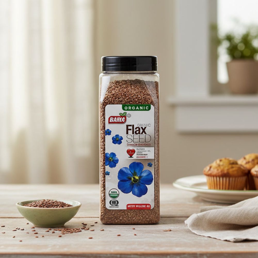 Badia Organic Ground Flax Seed, 16 oz container on top of a kitchen counter with a bowl of seeds beside it.
