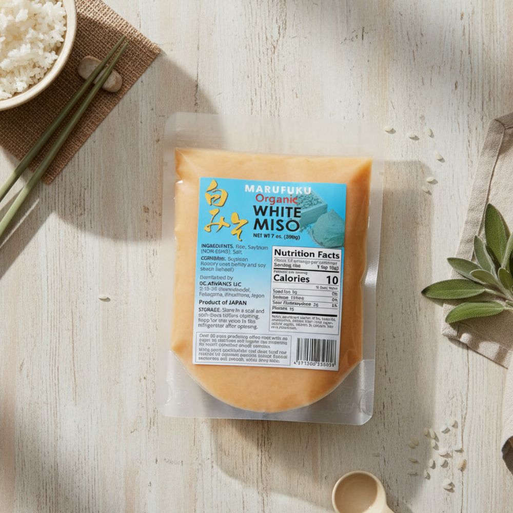 MARUFUKU Authentic Shiro White Miso paste, 7.0 OZ container laying on a kitchen table.